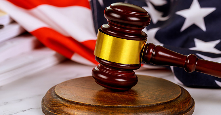Judge’s gavel resting on a block with a U.S. flag in the background, to symbolize a case about buy-sell agreements