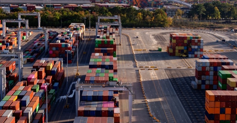 A lot filled with multicolor freight transportation boxes, suggesting global trade and economics